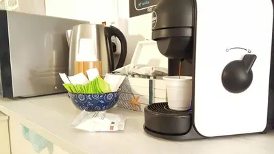 a counter with a coffee maker and a cup on it at Mediterraneo in Palermo