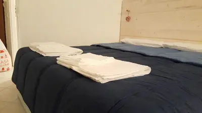 two white towels are on top of a bed at Mediterraneo in Palermo