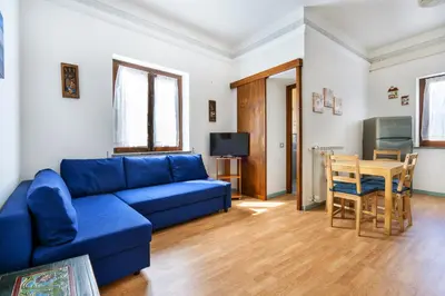 a living room with a blue couch and a table at Porta Carini Residence in Palermo
