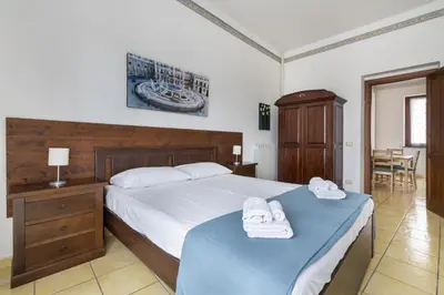 a bedroom with a bed with towels on top of it at Porta Carini Residence in Palermo