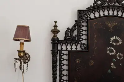 a clock on a wall next to a lamp at B&B Malvasia in Palermo