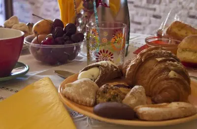 a plate of bread and pastries on a table at ilgiardinodellanonna in Castelluzzo
