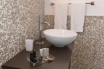 a bathroom with a white bowl sink on a counter at Palazzo Ducale Suites in Monreale
