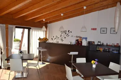 a kitchen with two tables and white chairs at Palazzo Ducale Suites in Monreale