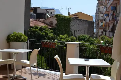 a balcony with two tables and chairs on a balcony at Palazzo Ducale Suites in Monreale