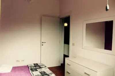 a bedroom with a bed and a dresser and a mirror at Villa Aga in Campofelice di Roccella