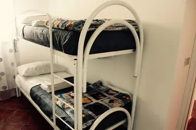 a room with three bunk beds in a room at Villa Aga in Campofelice di Roccella