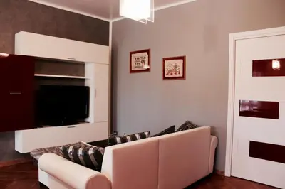 a living room with a couch and a flat screen tv at Villa Aga in Campofelice di Roccella