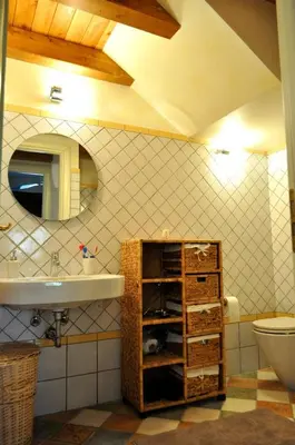 a bathroom with a sink and a toilet at Villa Le Meraviglie in San Vito lo Capo