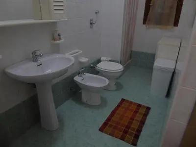a bathroom with a sink and a toilet at Appartamento Marconi 15 in San Vito lo Capo