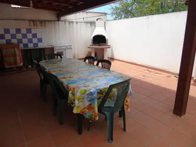 a table and chairs with a table and a stove at Appartamento Marconi 15 in San Vito lo Capo