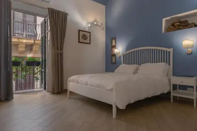 a bedroom with a bed with a blue wall at Novelli 36 in Palermo