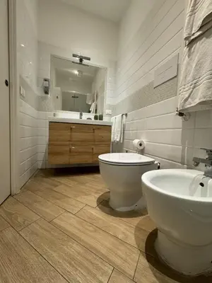 a bathroom with a tub and a toilet and a sink at Novelli 36 in Palermo