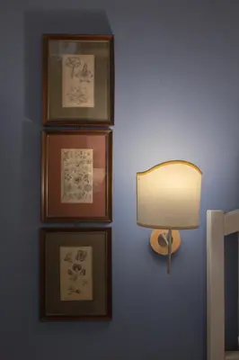 a wall with four pictures and a lamp on a wall at Novelli 36 in Palermo