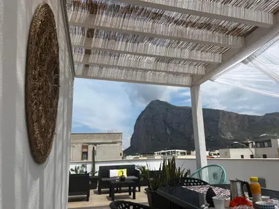 a patio with a view of a mountain at sicily home casa vacanze con piscina in San Vito lo Capo