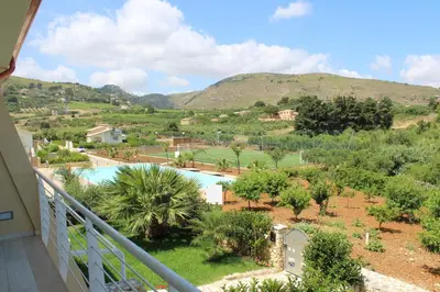 a view of a pool from the balcony of a house at Borgo Aranci - Villetta Peonia B3 - Castellammare del Golfo in Castellammare del Golfo