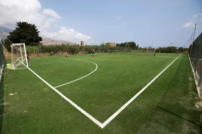 a group of people playing soccer on a soccer field at Borgo Aranci - Villetta Peonia B3 - Castellammare del Golfo in Castellammare del Golfo