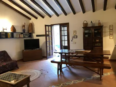 a living room with a table and a couch at Villa Mariza in Scopello