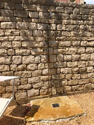 a stone wall with a grate in front of it at Villa Mariza in Scopello