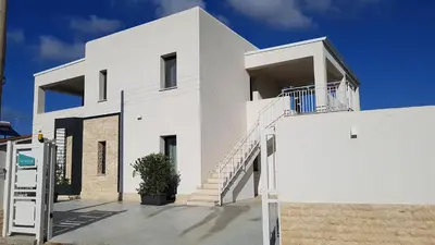 a white house with stairs on the side of it at Villa Vo' Scurá in Alcamo Marina