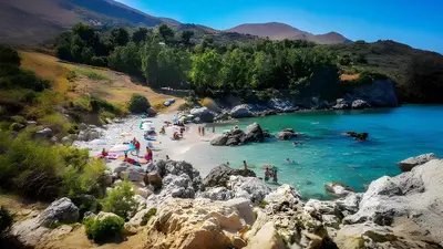 a group of people on a beach in a river at Villa Calamazzo in Scopello