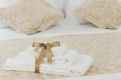 a pile of towels sitting on top of a bed at SUITE 188 - Welcome in Palermo
