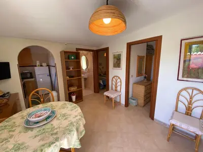 a room with a table and chairs and a refrigerator at Villa Paloma in Castellammare del Golfo