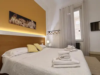 a bedroom with a bed with towels on it at Aziz b&b in Palermo