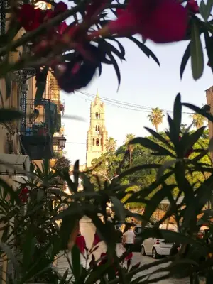 a building with a clock tower in the background at Casa Busari in Palermo