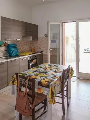 a kitchen with a table and chairs and a kitchen with a kitchen at CASA 