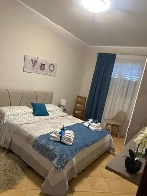 a bedroom with a bed with towels on it at appartamento residence via giardini Acquamarina in San Vito lo Capo