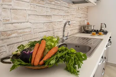 a basket of vegetables sitting on a kitchen sink at Borgo Aranci - Villetta a Schiera A1 in Castellammare del Golfo