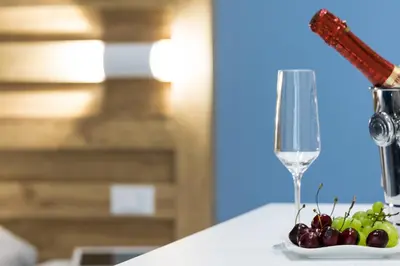 a plate of grapes and a wine glass on a table at B&B Acqua Azzurra in San Vito lo Capo