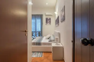 a small bedroom with a bed and a window at Kasavucciria Apartments in Palermo