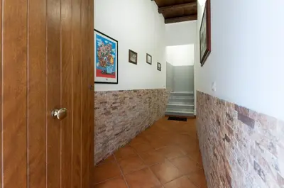 a hallway with a brick wall and a door at Kasavucciria Apartments in Palermo