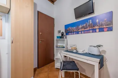 a room with a desk and a tv on the wall at Kasavucciria Apartments in Palermo