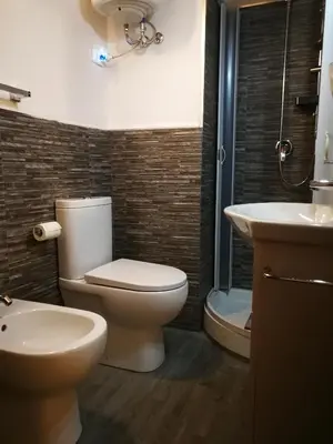 a bathroom with a toilet and a sink at Kasavucciria Apartments in Palermo