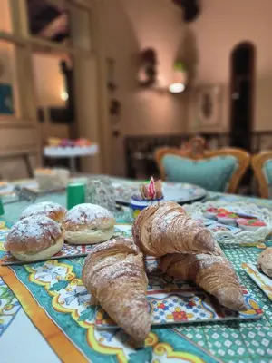 a table with plates of food on top of it at Vittorio Emanuele Rooms di Prinzi in Palermo