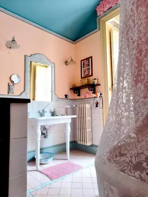 a table with a red table cloth with donuts on it at Vittorio Emanuele Rooms di Prinzi in Palermo