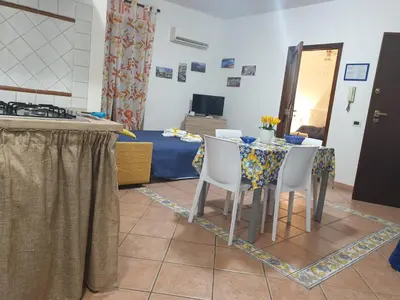 a dining room with a table and two chairs at Casa Palazzo Reale in Palermo