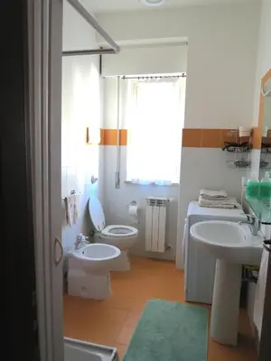 a bathroom with two sinks and a toilet and a window at Appartamento Libertà in Palermo