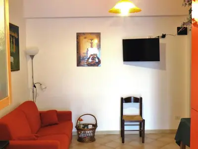 a living room with a couch and a tv on a wall at Appartamento Libertà in Palermo