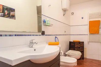 a bathroom with a sink and a toilet at Casa Ibiscus x2 in Palermo