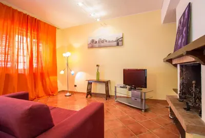 a living room with a couch and a television at Casa Ibiscus x2 in Palermo