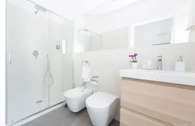 a white bathroom with a toilet and a shower at Dimora CentroWell in Palermo
