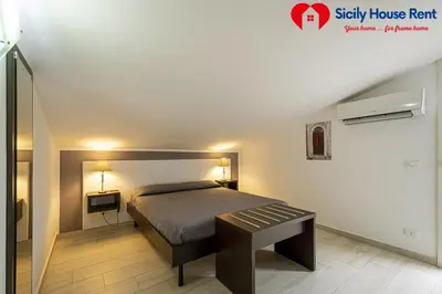 a small bedroom with a bed and a table at Borgo Aranci - Appartamento in Villa Garofalo - 15B in Castellammare del Golfo