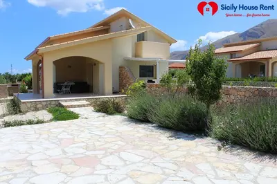 a house with a stone patio in front of it at Borgo Aranci - Appartamento in Villa Garofalo - 15B in Castellammare del Golfo