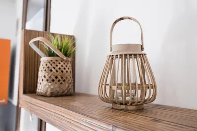 a bird cage sitting on a wooden shelf with a vase at LuminHouse Mondello Arancia in Mondello