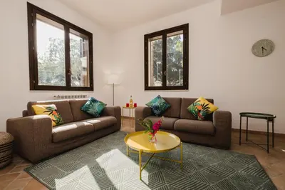 a living room with two couches and a table at LuminHouse Mondello Fico in Mondello