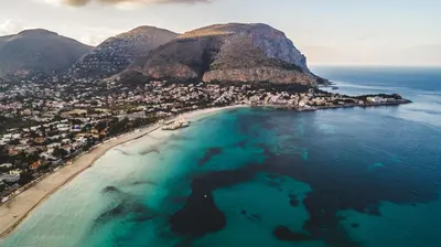 an aerial view of a beach next to the ocean at LuminHouse Mondello Limone in Mondello